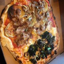 Pictured is one of our vegan pizzas: half funghi formaggi half salsiccia patate